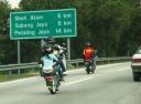 motorcyclistperformingawheelieatahighway.jpg